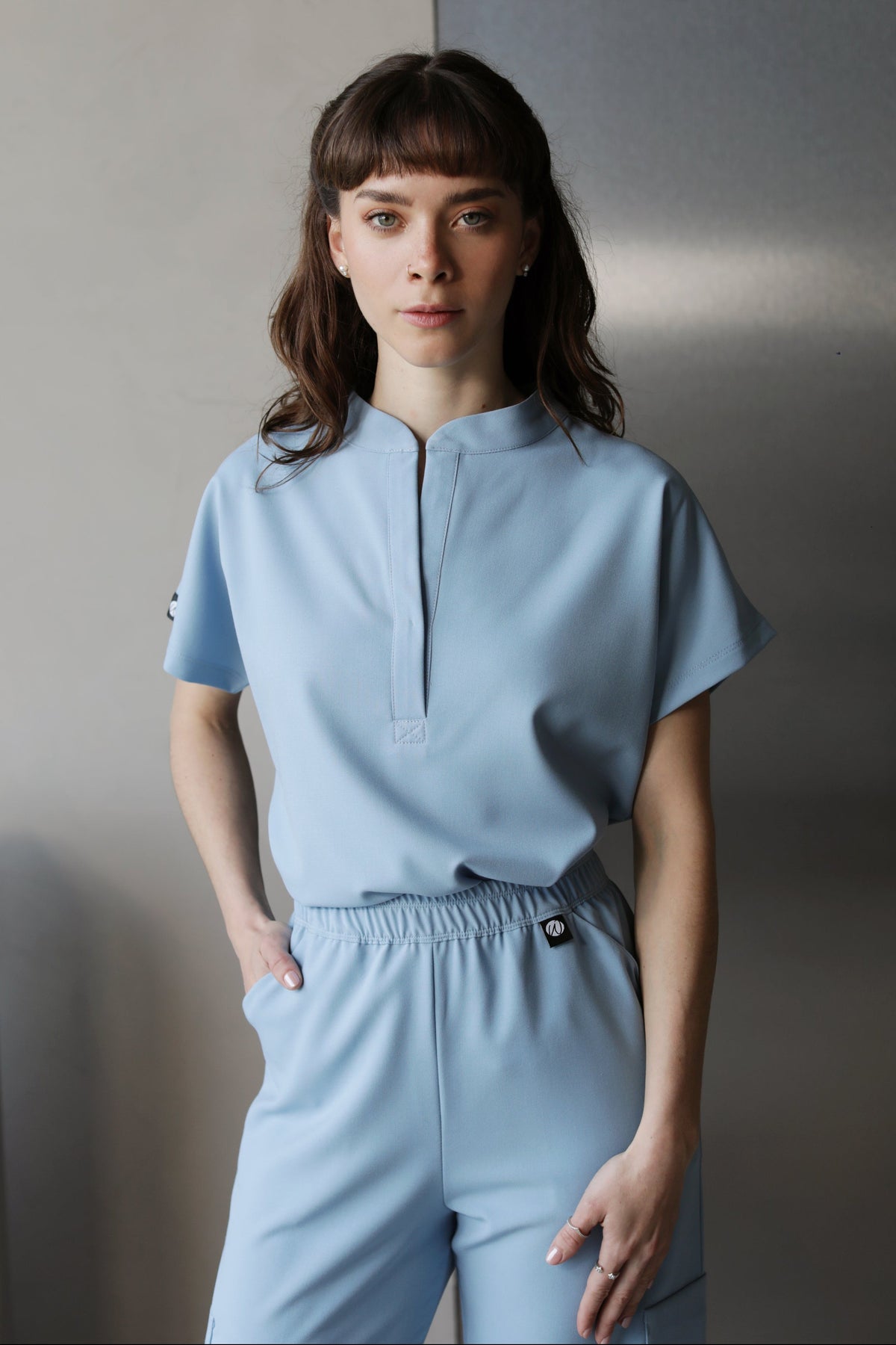 Woman wearing Glam Dream Blue Scrub Top by Work & Chill